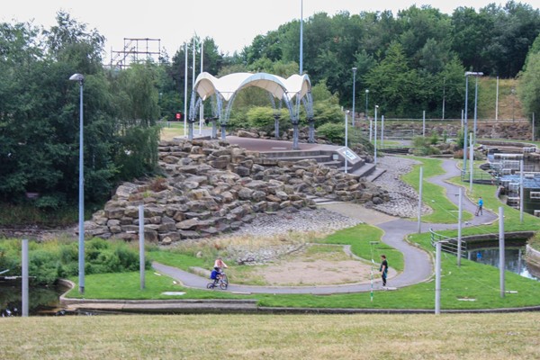 View of white water park with paths going around it.
