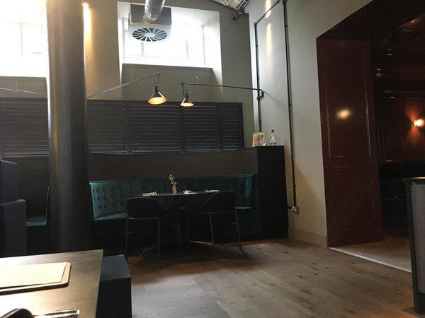 Image of the booth with two movable chairs at it.