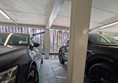 image of space at the side of the row of parking spaces with electric vehicle charging points