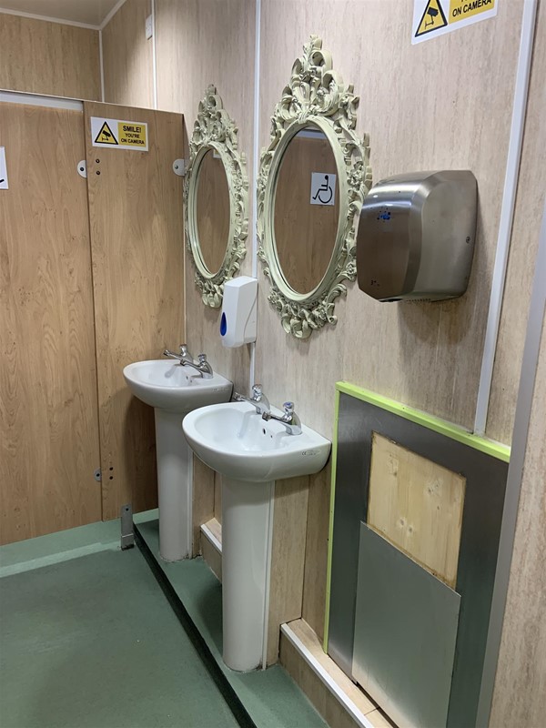 Image of two sinks, two mirrors and a hand drier