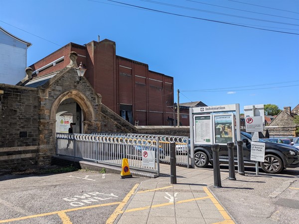 Image of entrance to station via car park and walkway