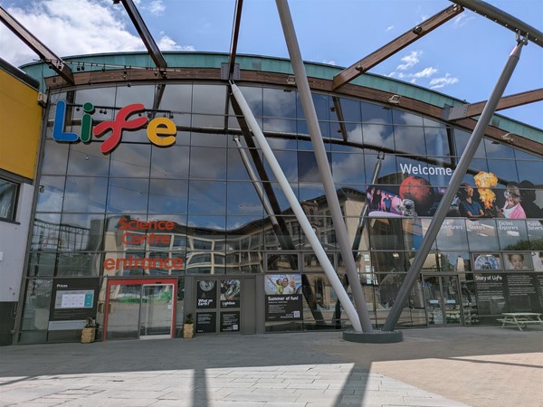 Image of the building from outside. A metal and glass building.
