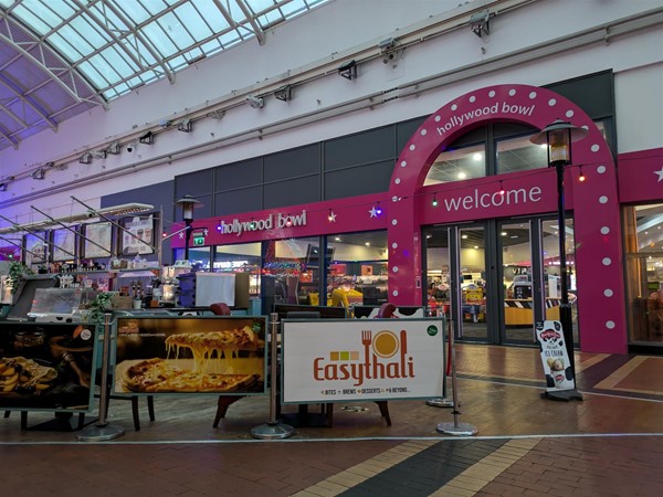 Image of Red Dragon Centre interior, there's a bowling alley and Diner and a restaurant in the middle of the floor named Easy Thai