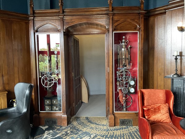 HIDEAWAY This most unusual card and board game room is fascinating, objects that will enthrall you. See old historical machines, unusual metal art transformed into practical fun loving items. Most unusual, all shown in this oak wood panelled walled room, dark ceiling, items enclosed in wooden boxes, all to impress you of what can be done with metal objects. Most interesting of the three rooms.