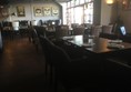 Spacious dining area with high tables enabling wheelchair access.