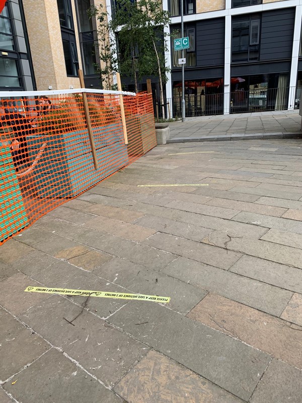 View of social distancing markers outside of garden area.
