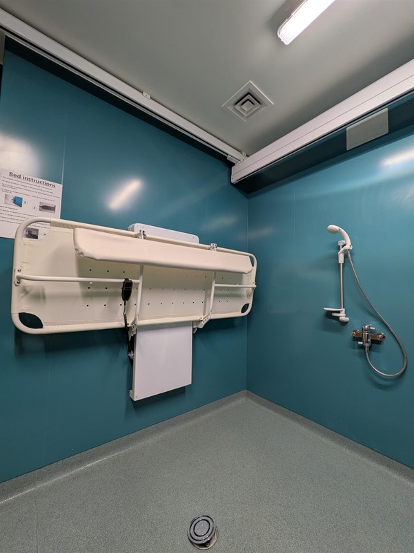 image of changing bench and ceiling hoist track in the Changing Places bathroom