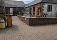 Sloped access to indoor seating and large flat outdoor patio